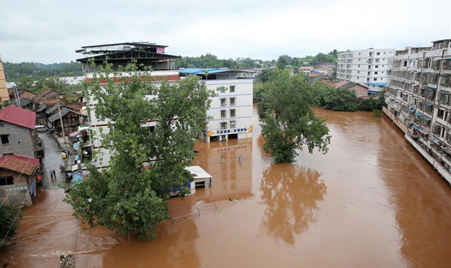 Heavy downpours force relocation of thousands in Sichuan